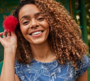 Women Smiling with a flower in her hair