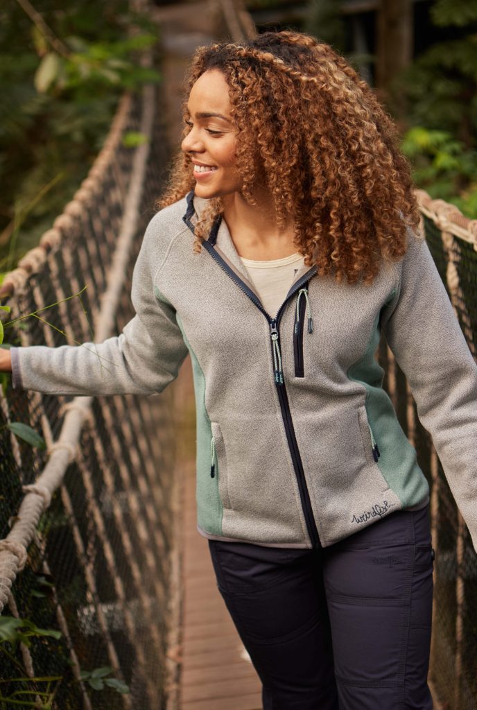 Women in a full zip hoodie on a bridge in cornwall